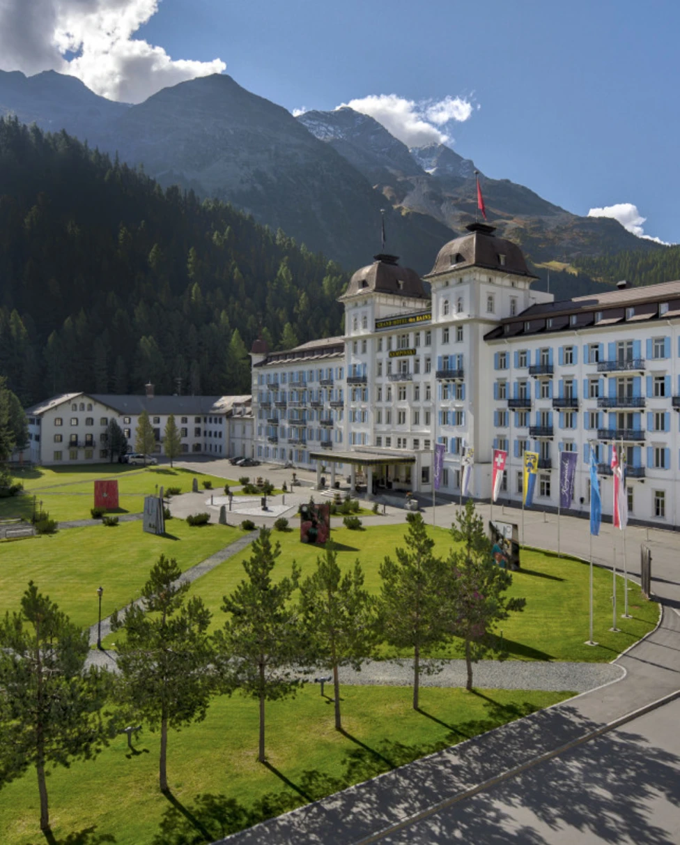 palatial hotel amid a lush mountain landscape