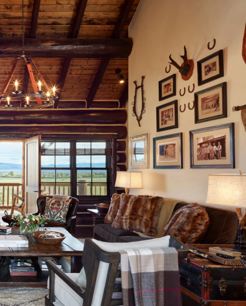 A cozy and luxurious living room of a cabin with a beautiful view.