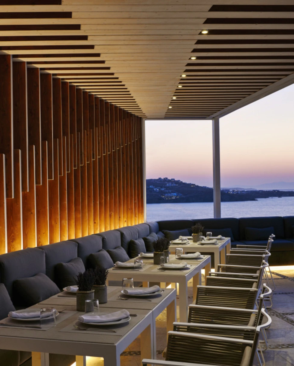 Restaurant patio overlooking ocean with sunset in background