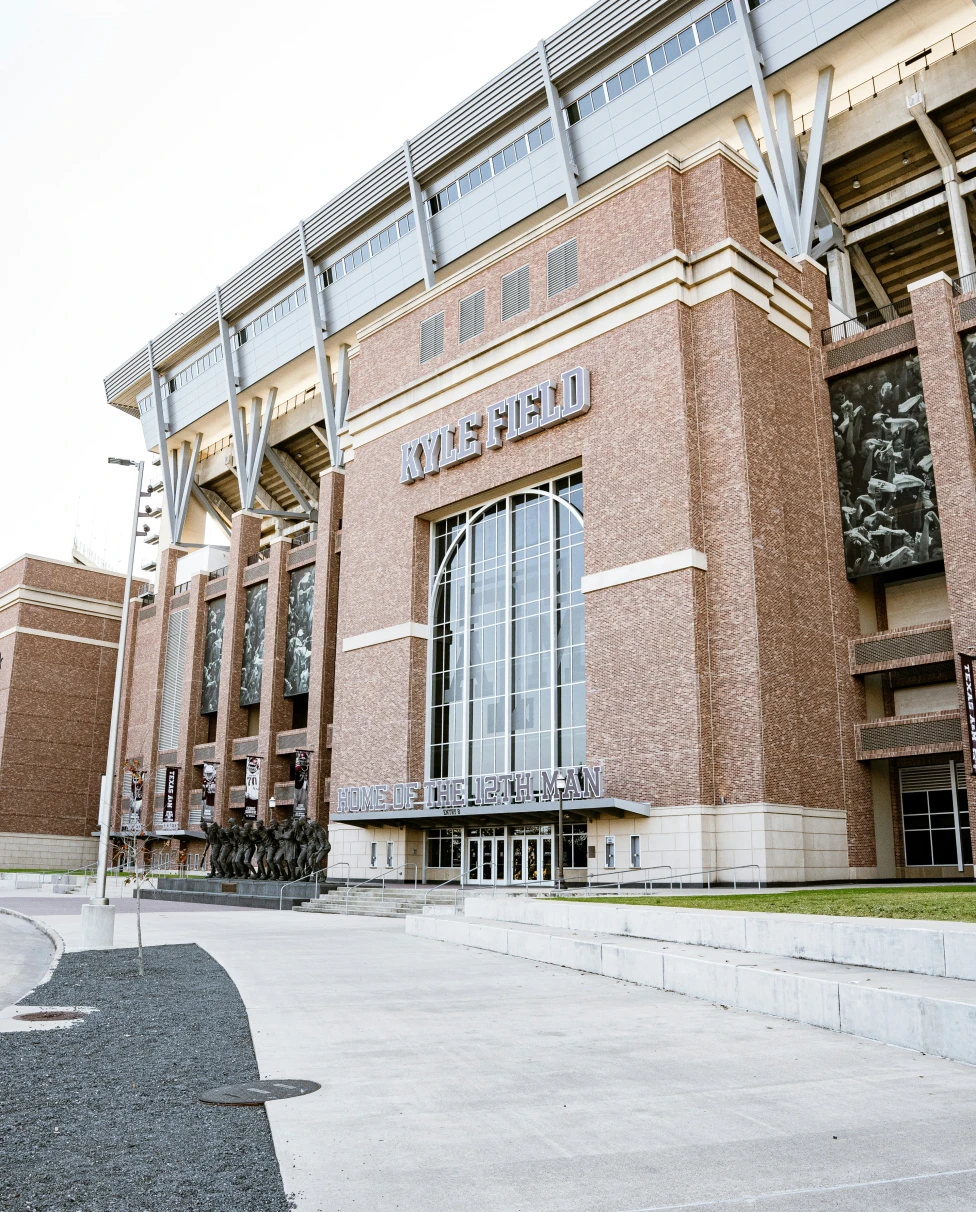 A large brick building with a sign reading "Kyle Field"