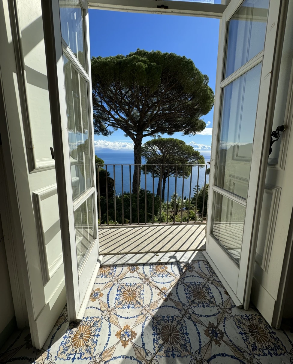 Door opening into terrace with ocean view.