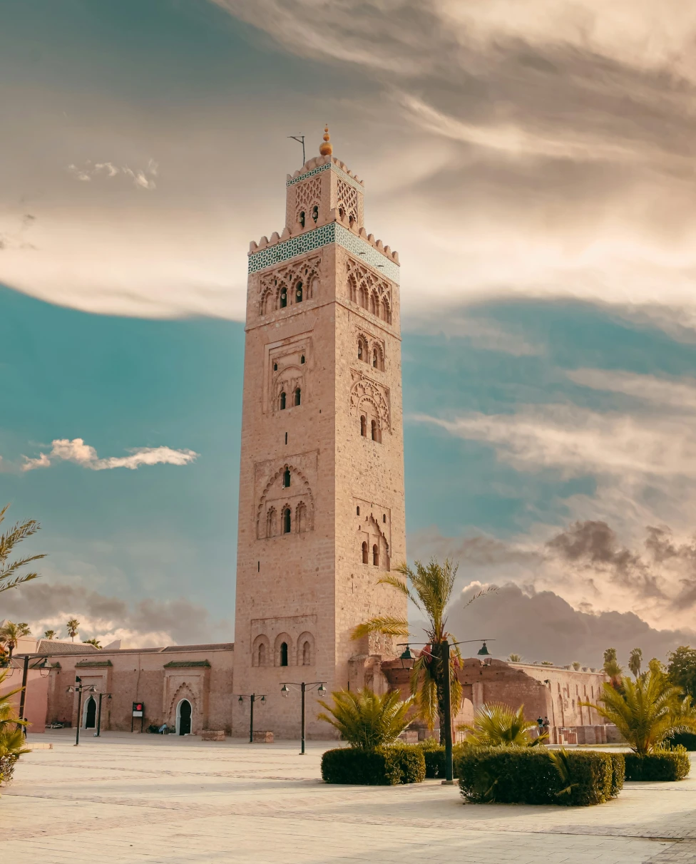 A 12th-century landmark against a blue sky with clouds.