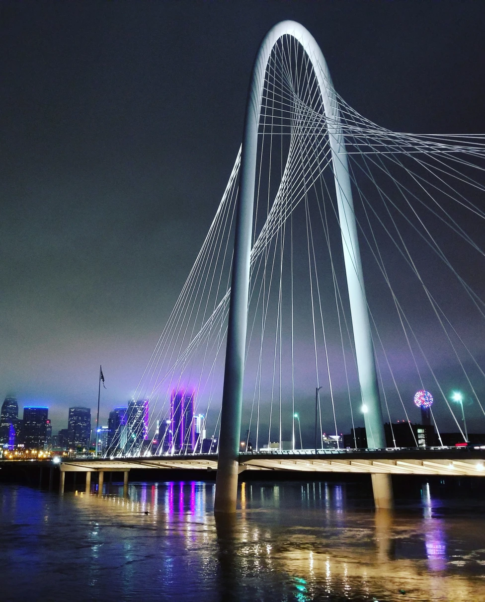 The Ronald Kirk Pedestrian Bridge is a stunning architectural landmark spanning the Trinity River in Dallas, Texas, offering pedestrians and cyclists picturesque views of the city's skyline.