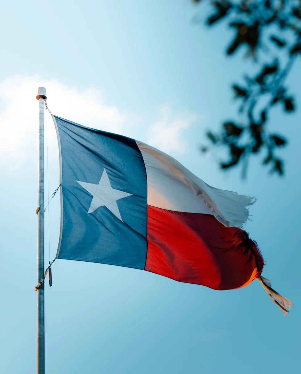 Texas flag with a blue sky in the background
