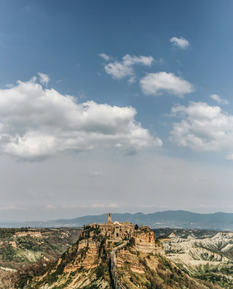 Brown rock formation under blue sky during daytime.