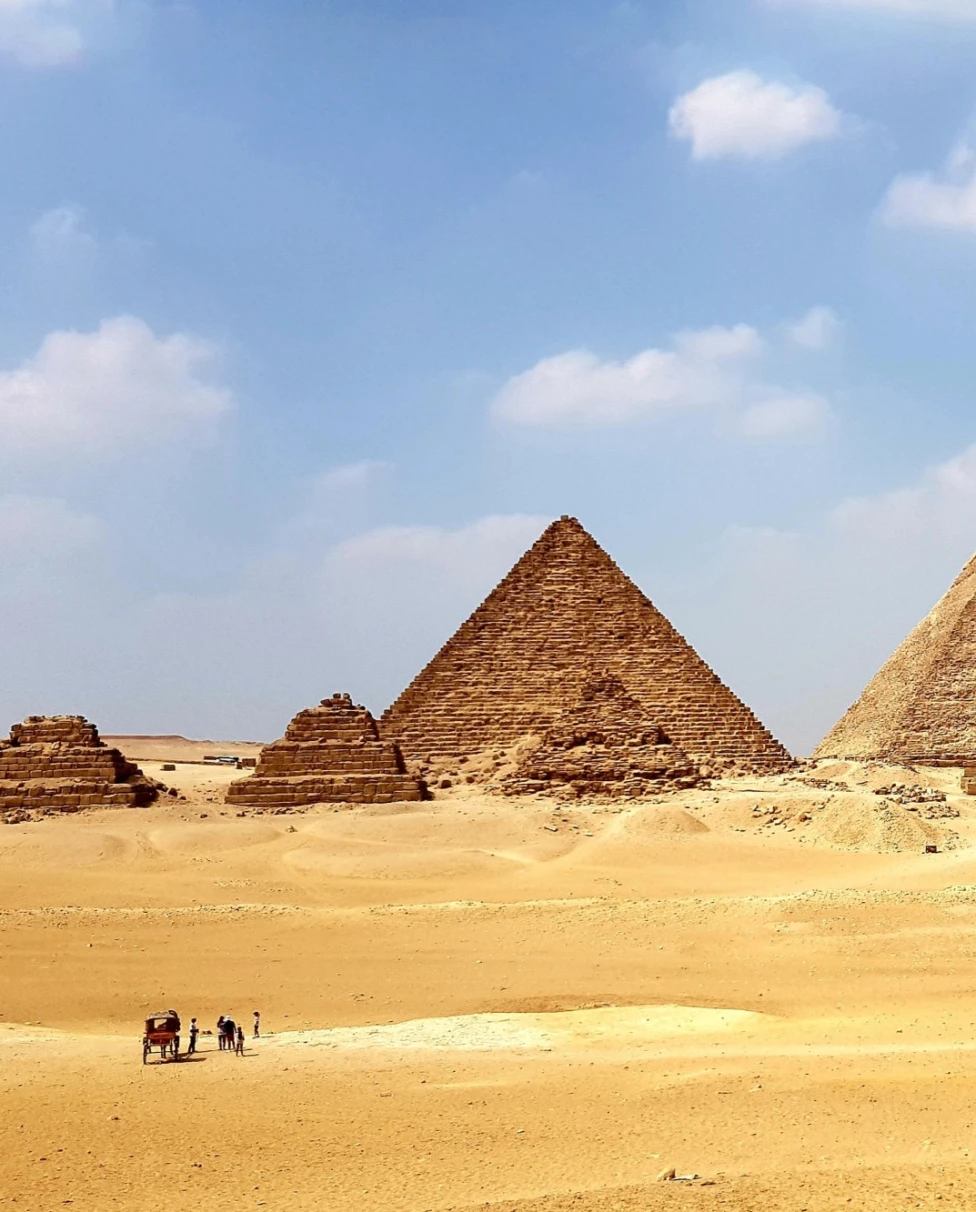 Egyptian pyramids on a yellow sandy desert on a sunny day