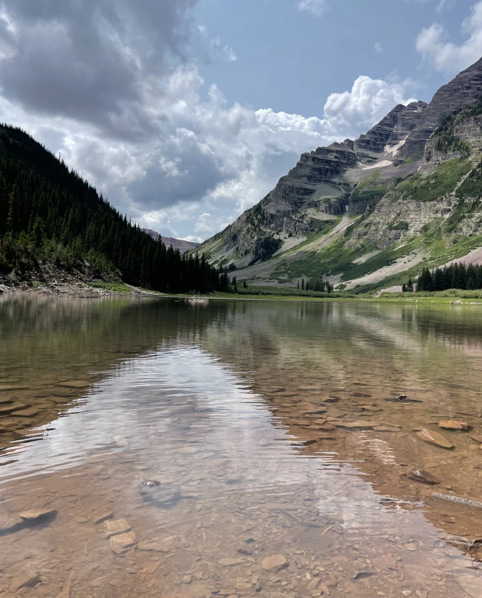 A landscape reflected on water, with the photo taken at an angle that makes it hard to distinguish where the land ends and the reflection begins, taken during a hiking trip in Aspen, Colorado.