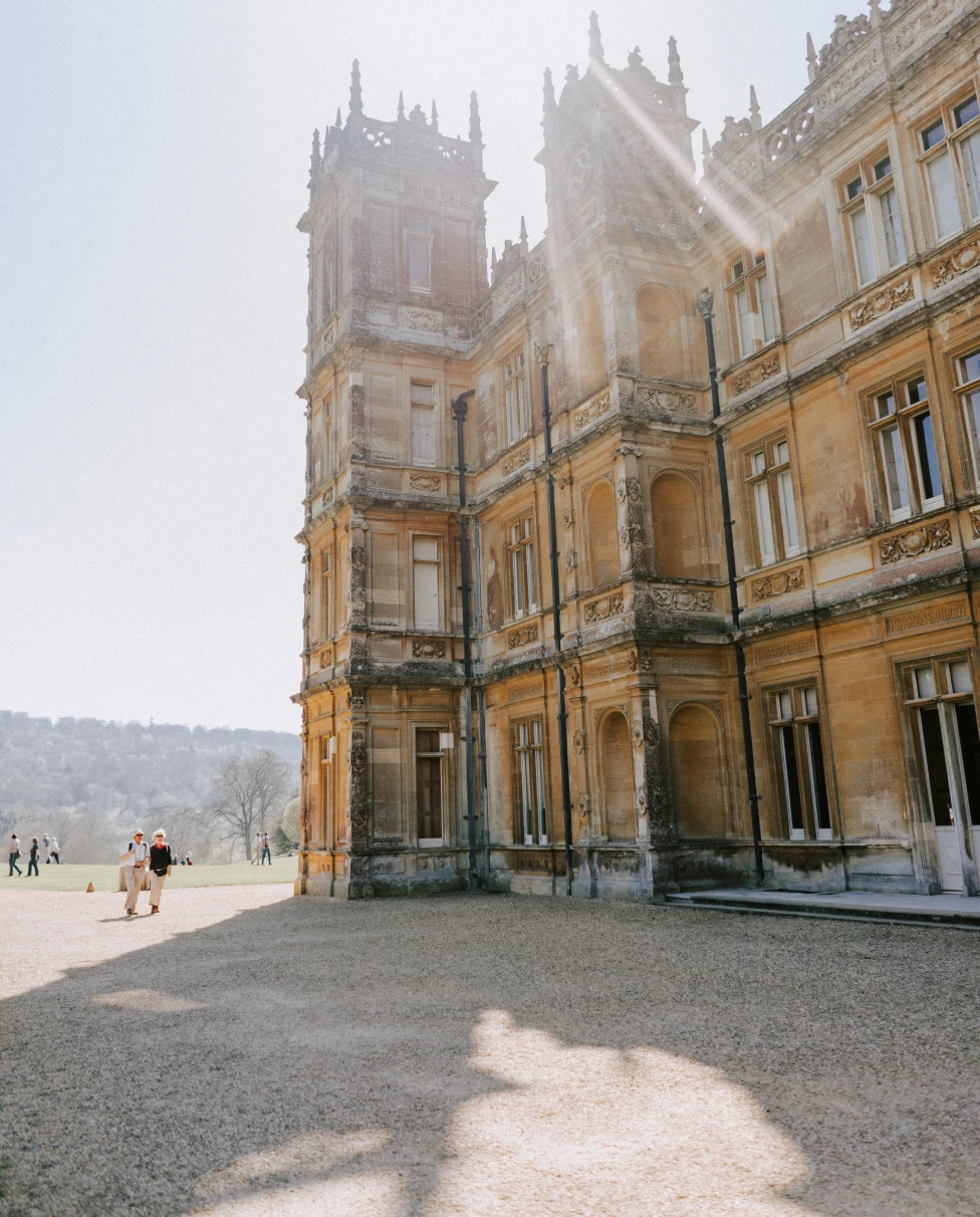 Highclere Castle is a stately English country house showcasing historical grandeur and elegance.
