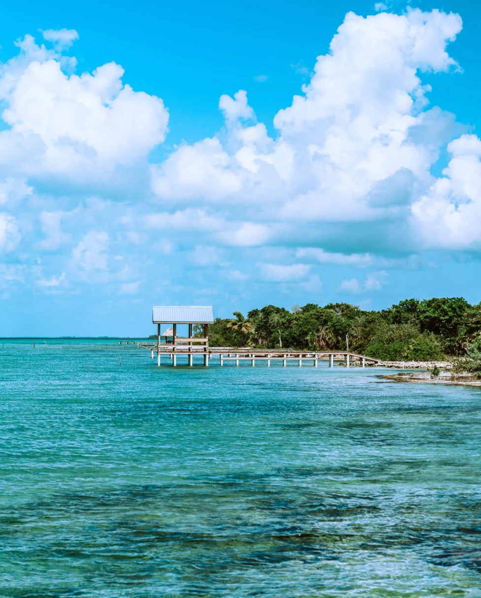 wooden pier jutting out onto a turquoise sea