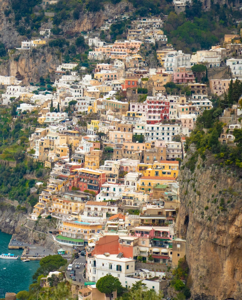 Aerial view of buildings on a cliffside by the ocean.