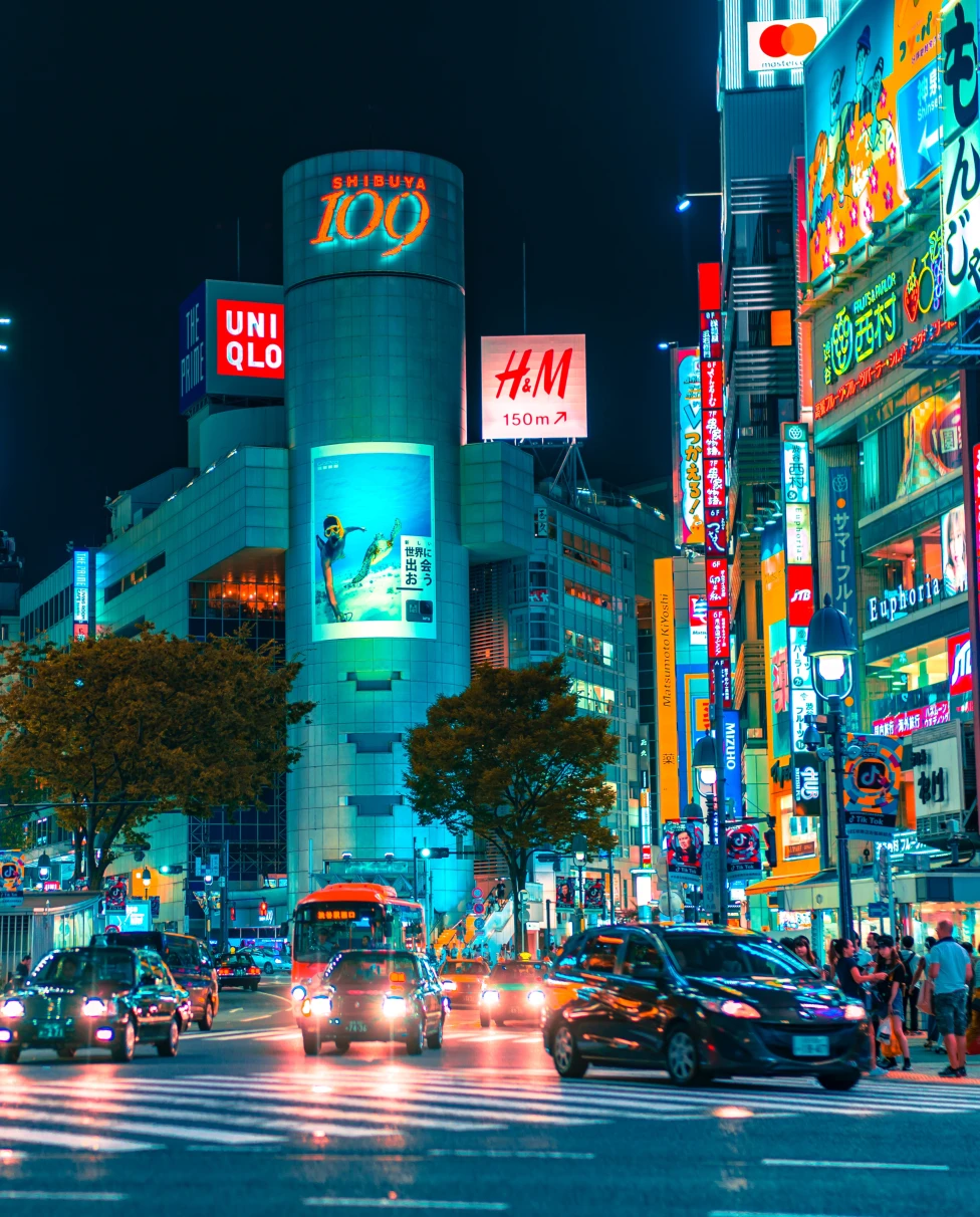 A street view at night with a lot of billboards