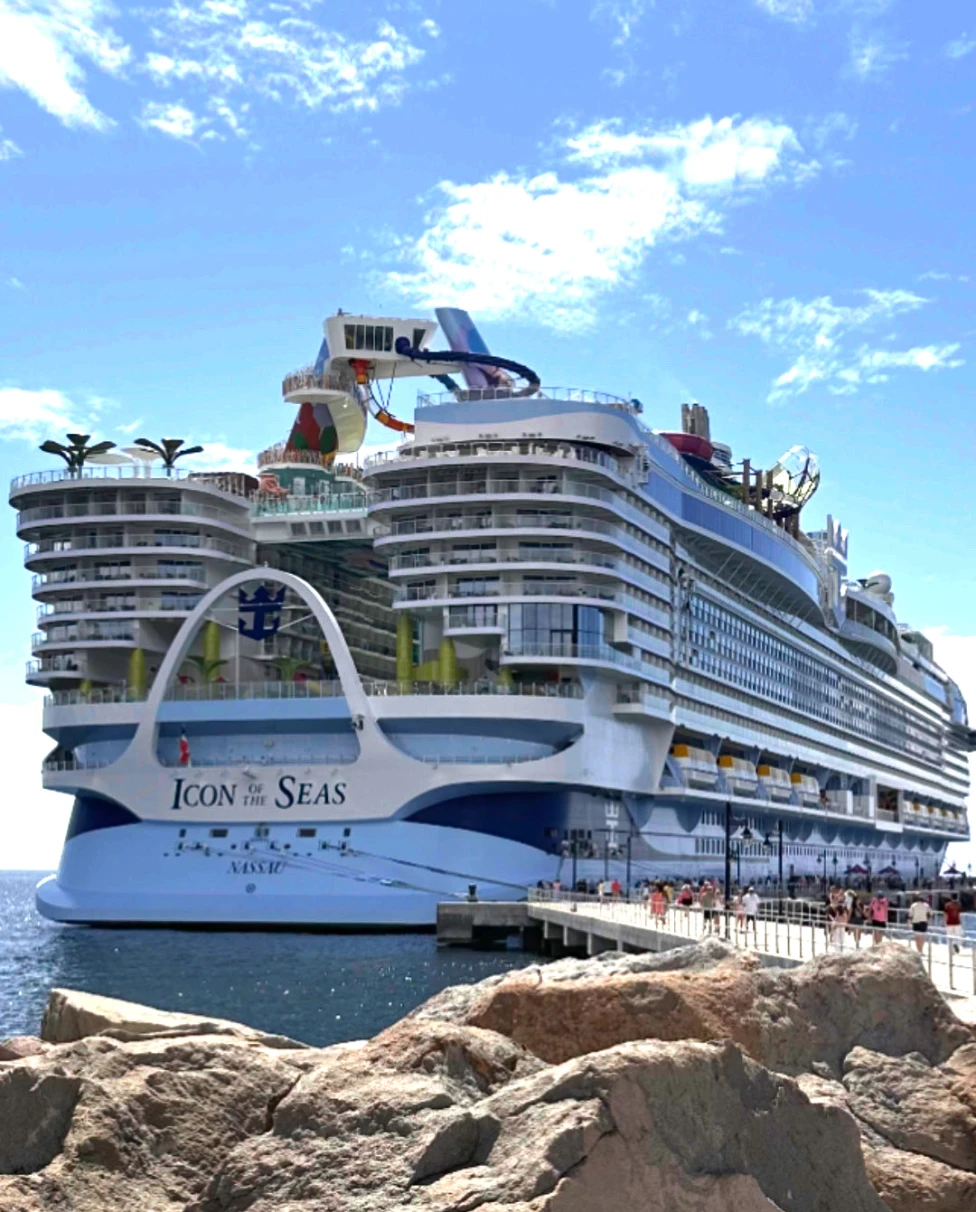 A cruise ship with the name Icon Of The Seas on the ocean.