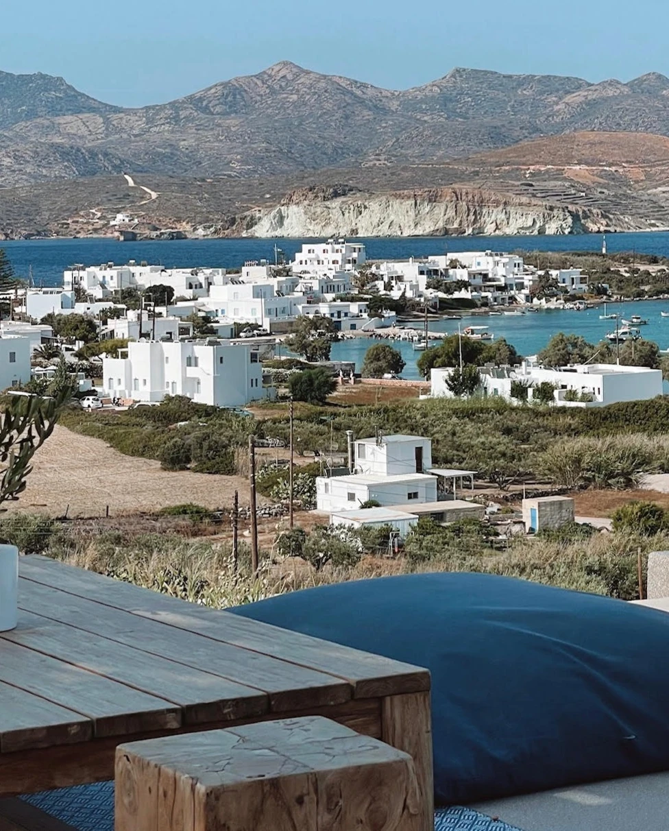 View of water body, city buildings and mountains from a roof top.