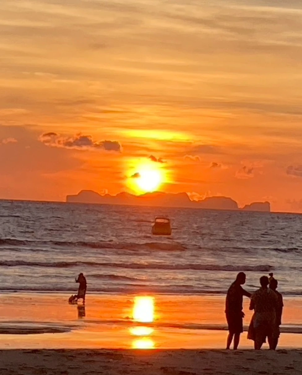 A beautiful golden sunset over the endless ocean on the beach.