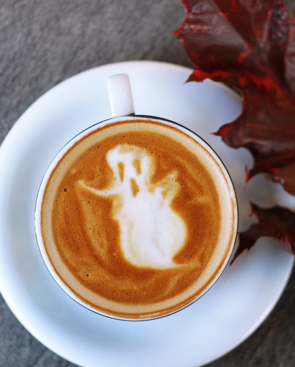 A white coffee cup with ghost pattern.