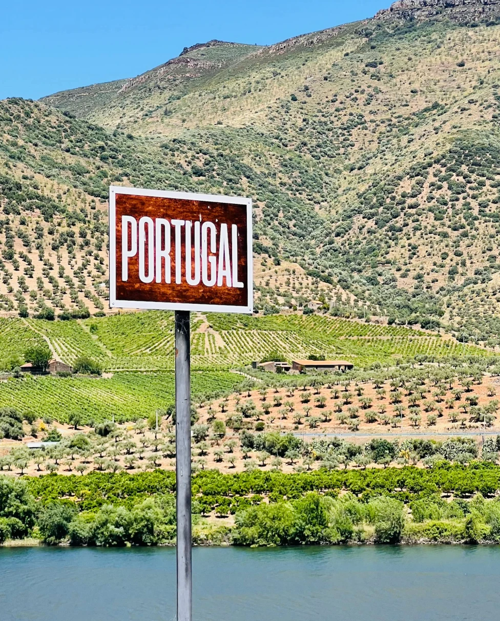 Signage in front of a hill in Portugal.