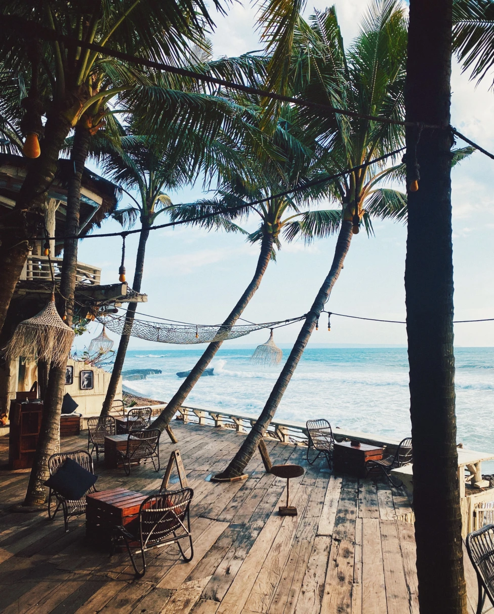 Wooden hut hotel in Bali with ocean views.