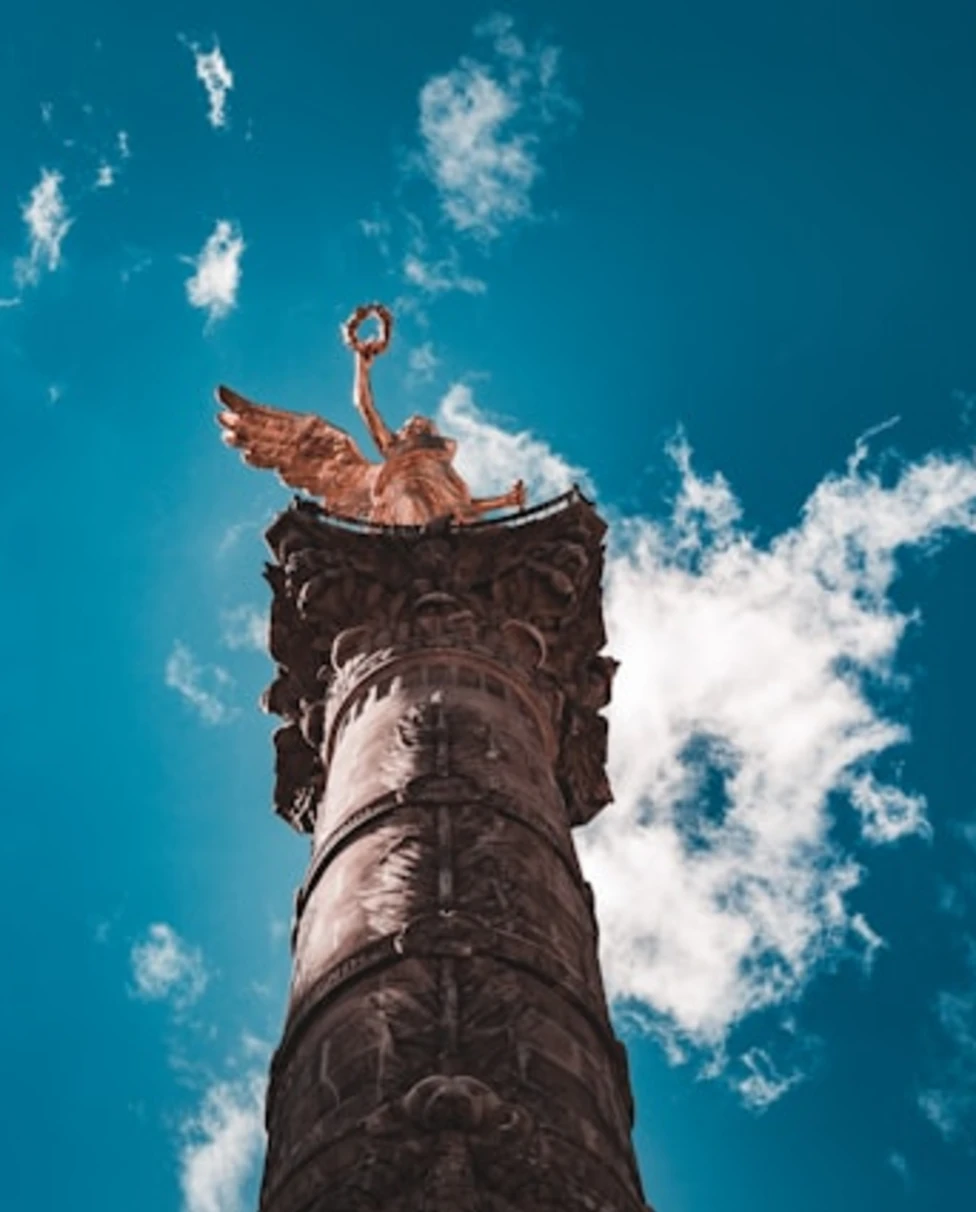 A low-angled photo of a statue during the daytime