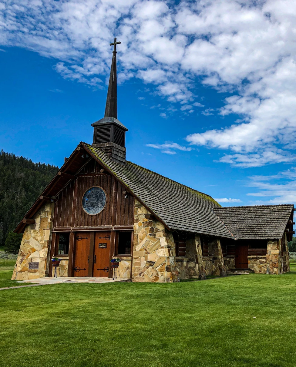 A hut with steeple in green mountains.