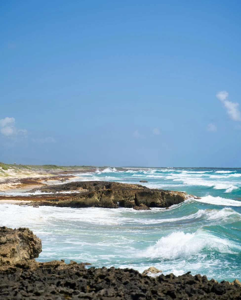 The shoreline of Cozumel with waves in the ocean.
