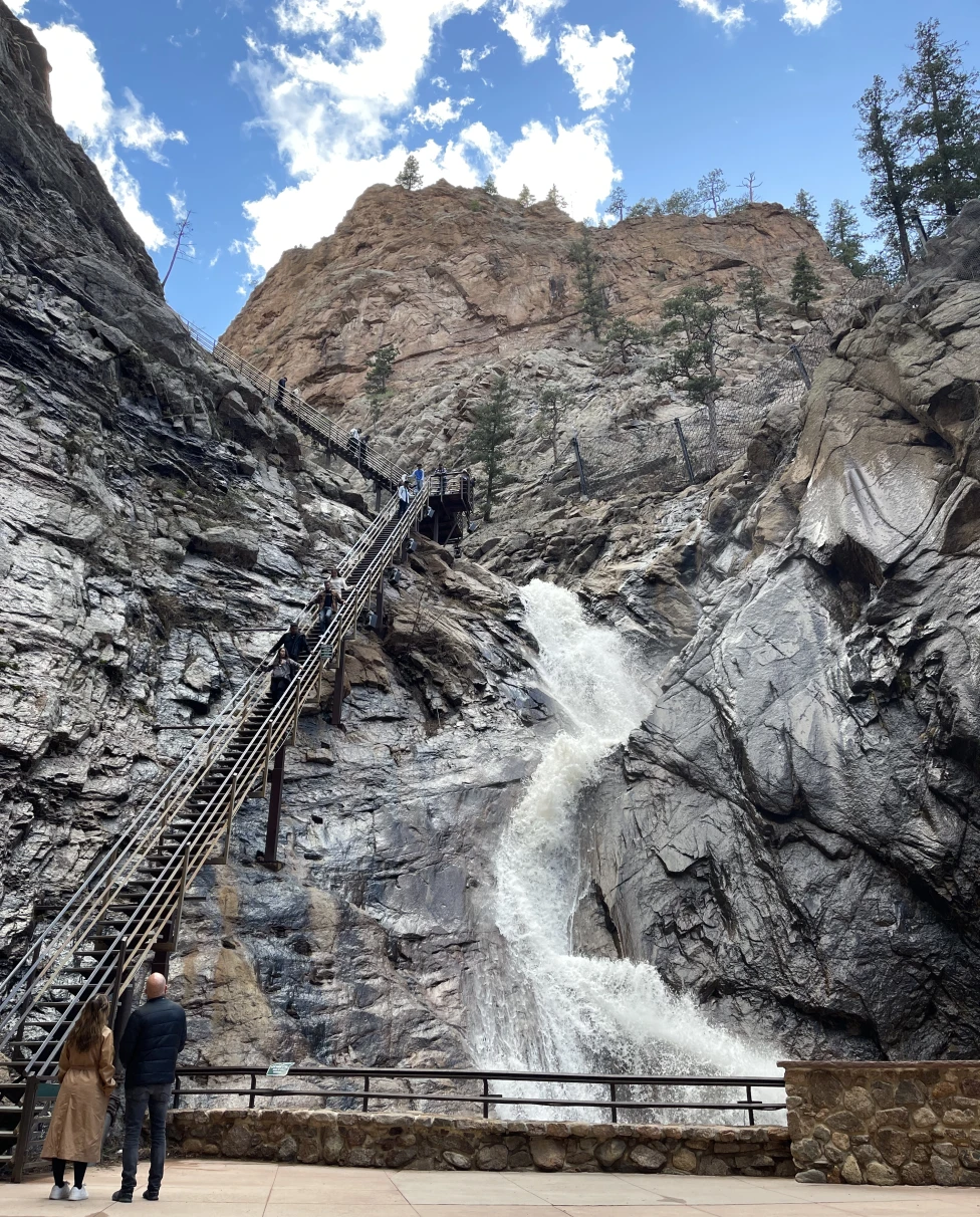 A waterfall down a mountain during the daytime