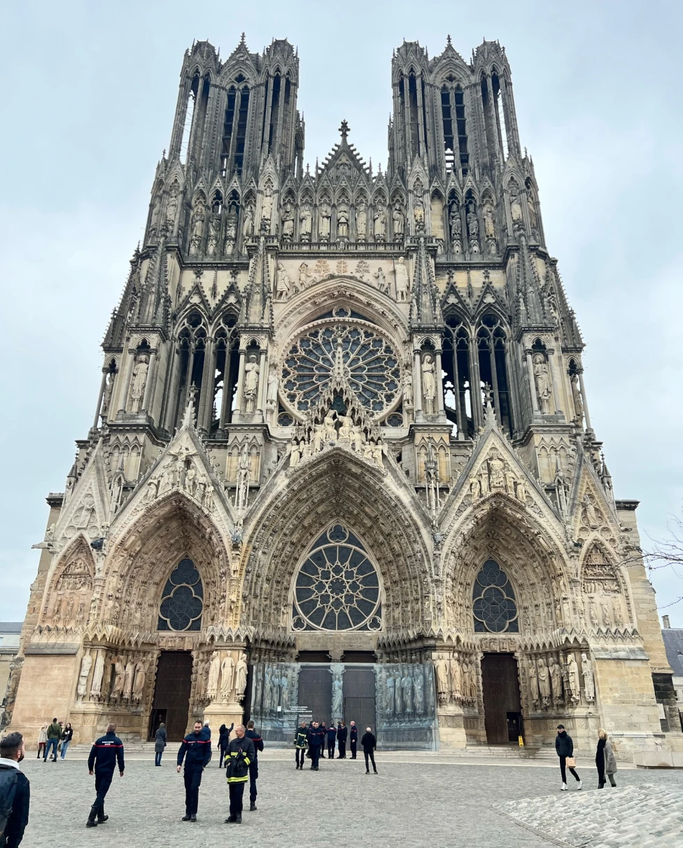 A front view of the majestic Reims Cathedral with its gothic architecture