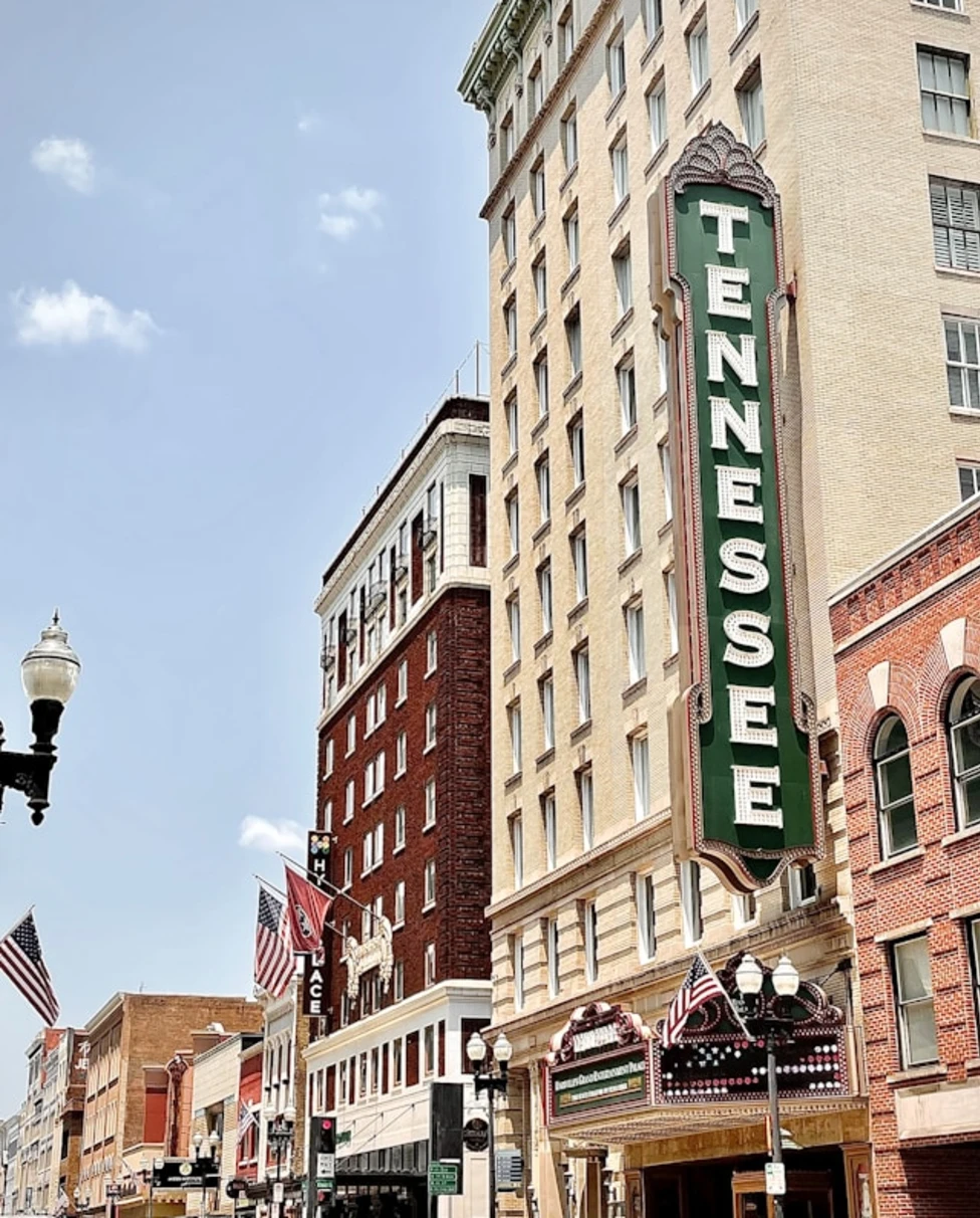 brown concrete building with green and white signage reading "TENNESSEE"