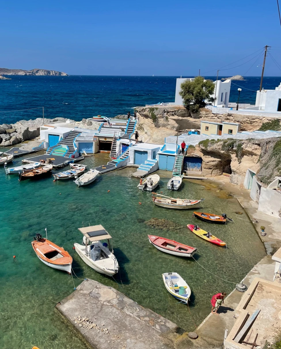 An aerial view of the shore with multiple boats anchored to the shore.