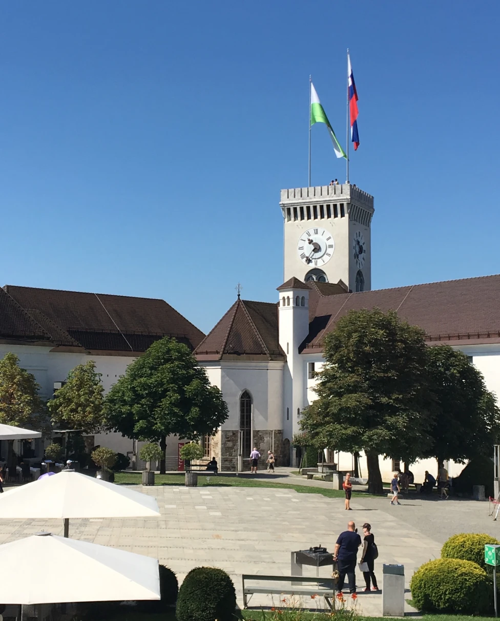 A castle with two flags on a sunny day.