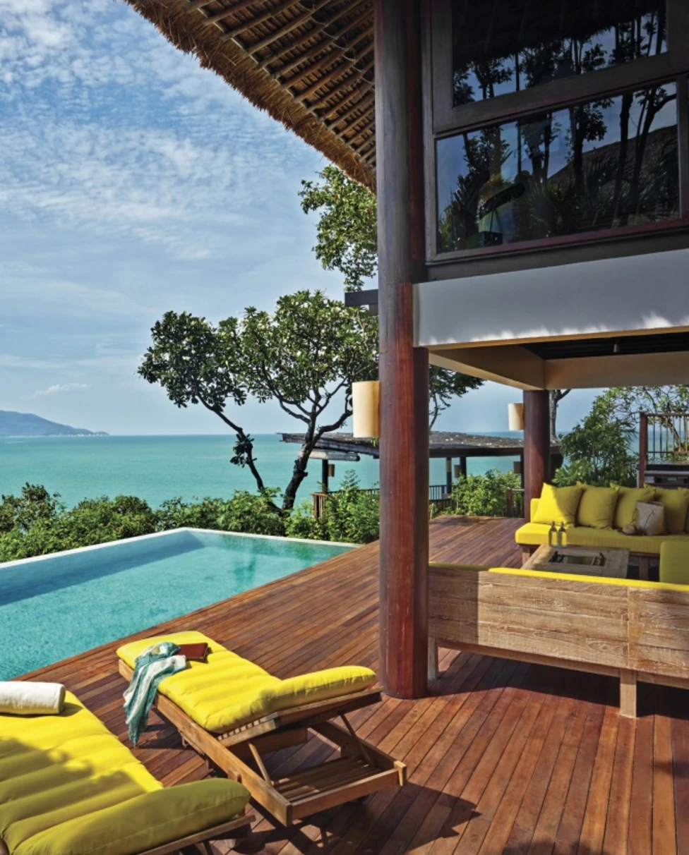 two yellow chairs on deck next to pool during daytime