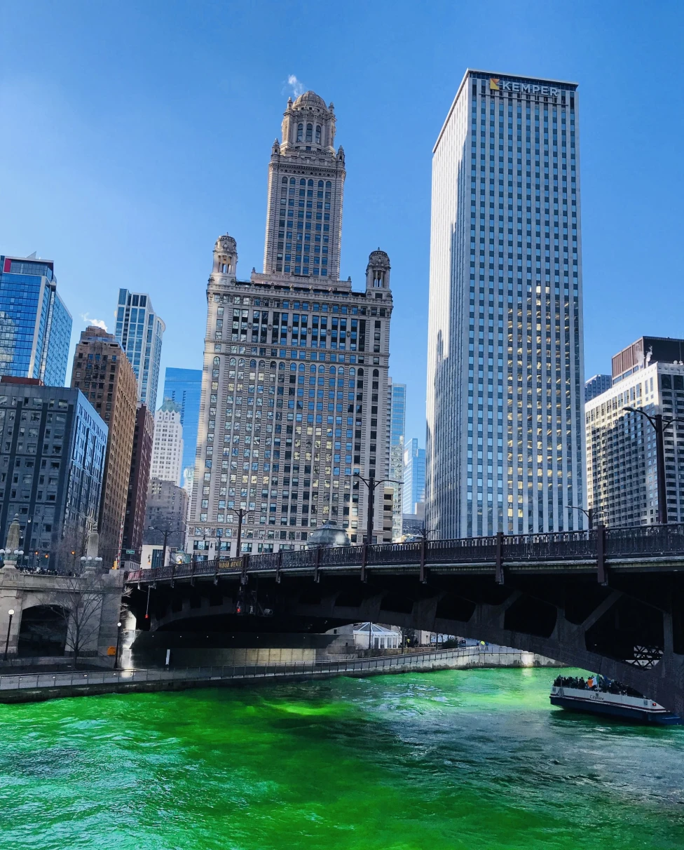 A low-angled shot of the Chicago River Walk with the water turned green for St. Patrick's Day.
