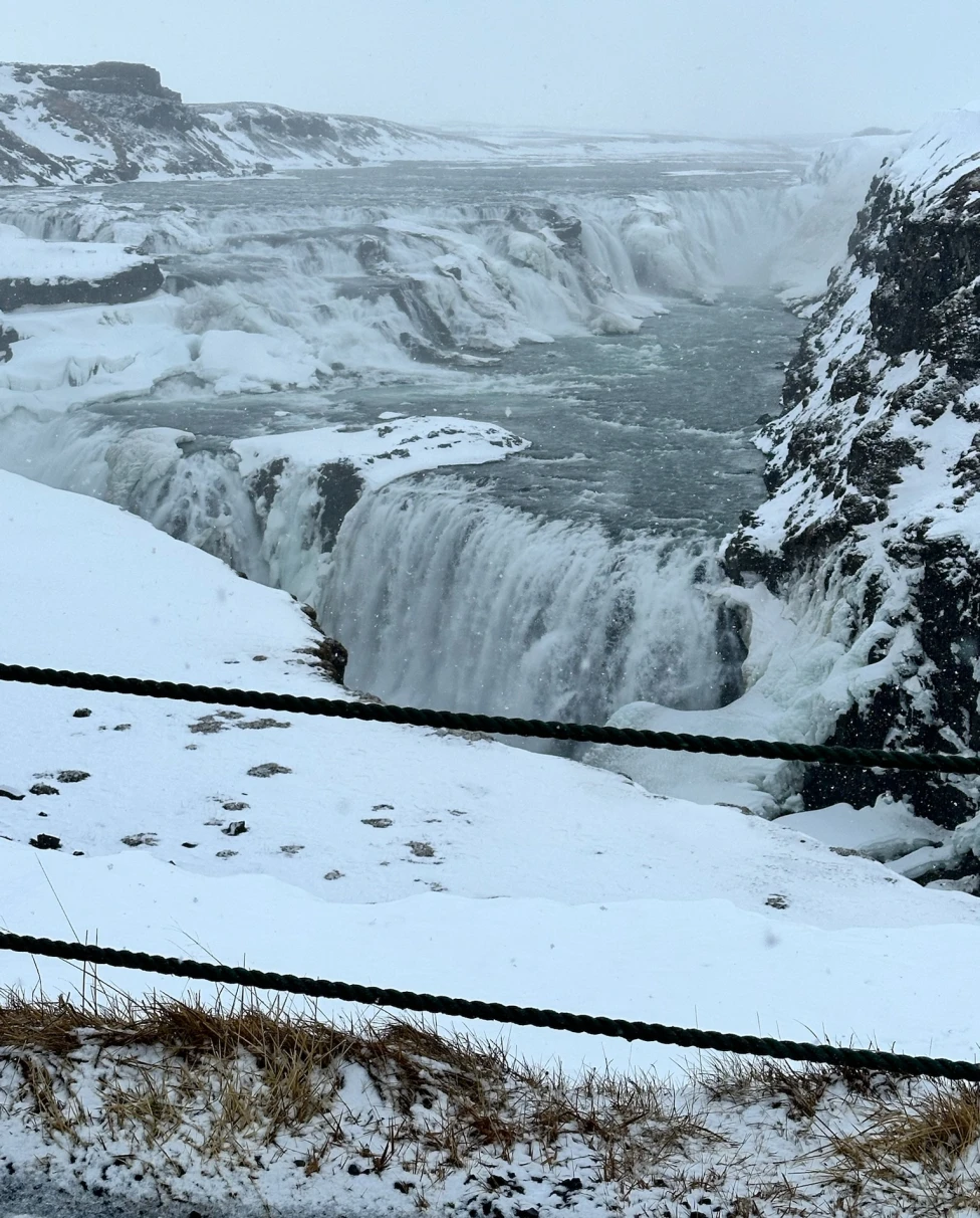 Gullfoss waterfalls in the winter, covered in snow.