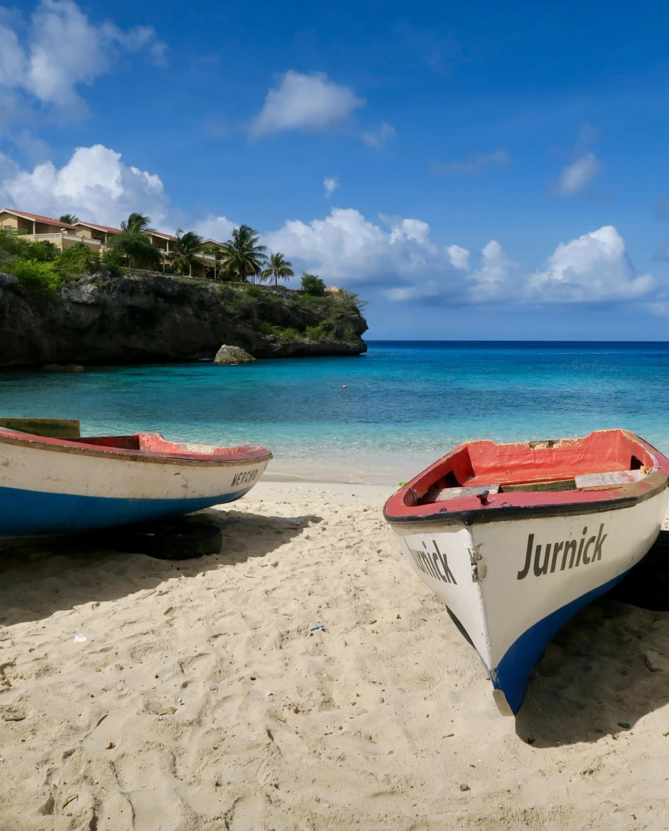 Two boats on a beach during day time.