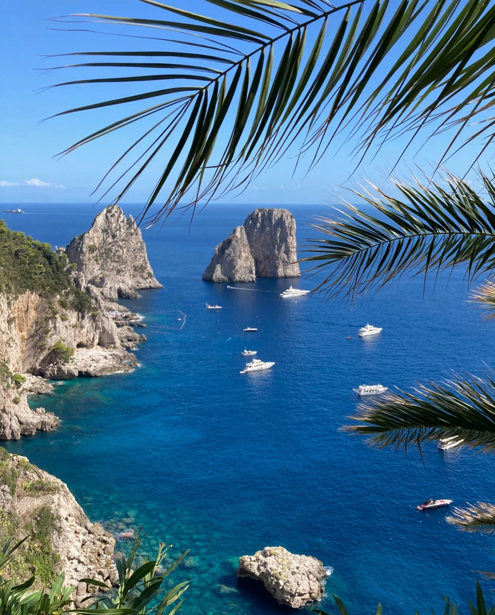 Capri coast, rock formations and boats.