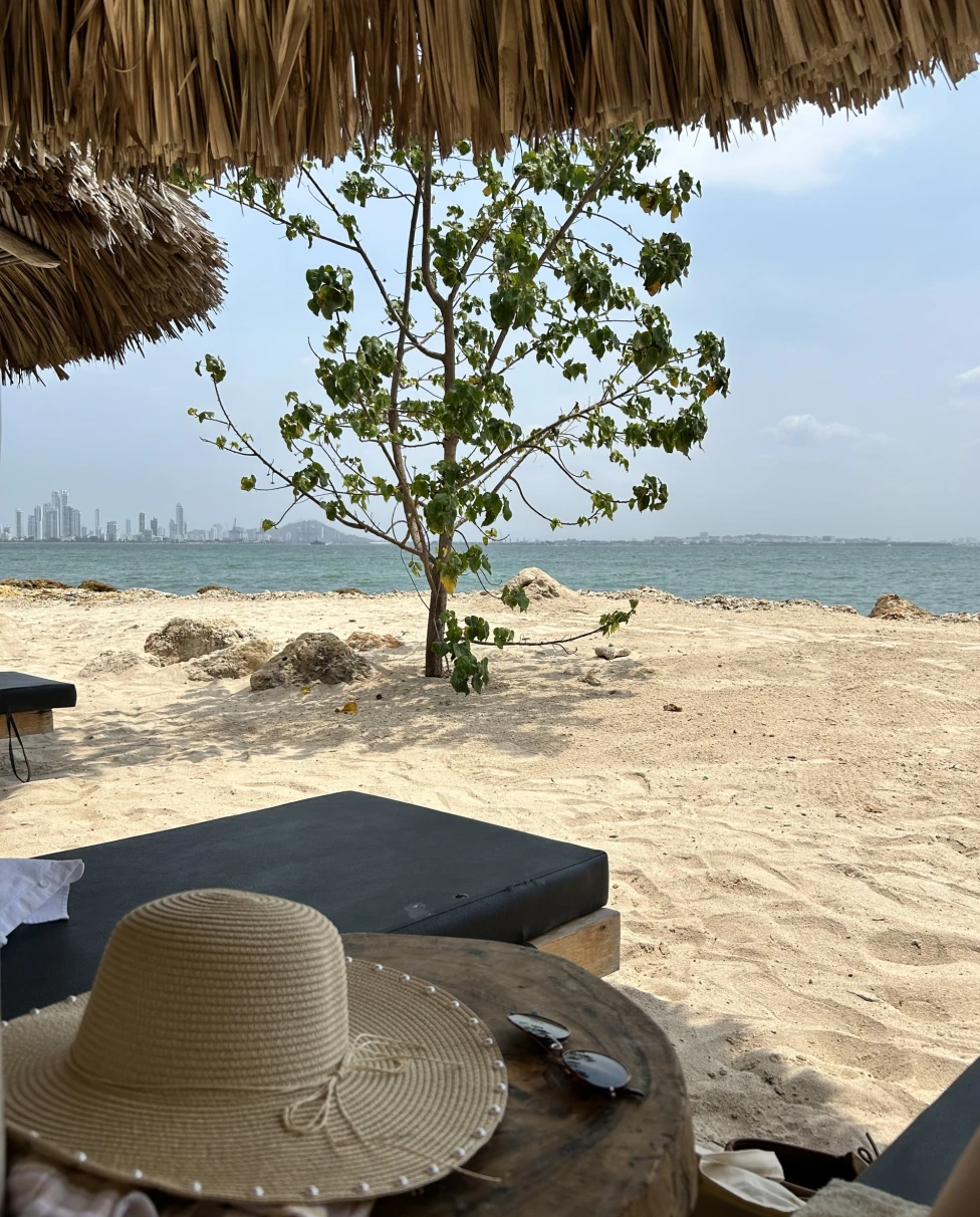 a hat on a beach table under umbrella
