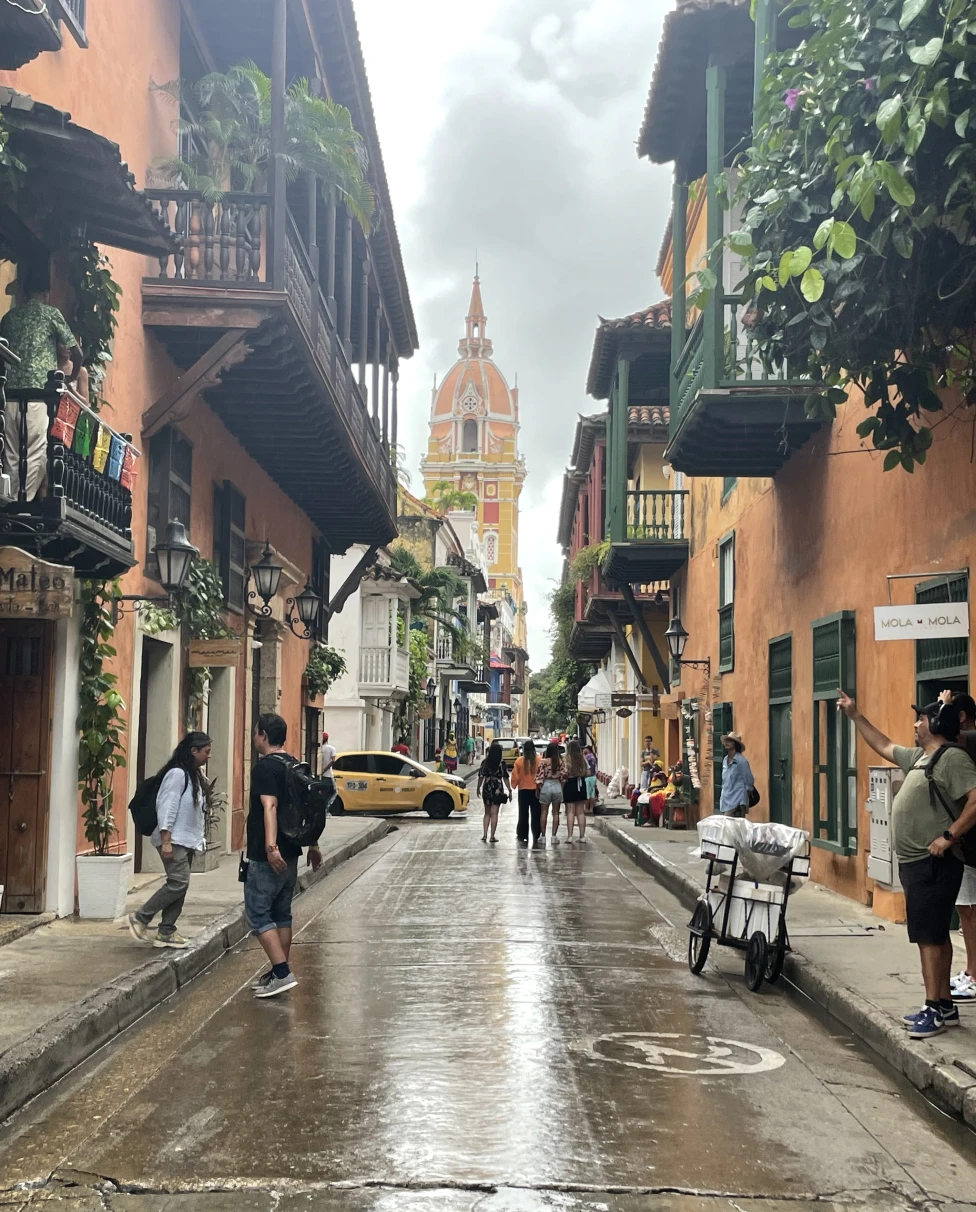 Streets of Cartagena with colorful buildings and pedestrians.