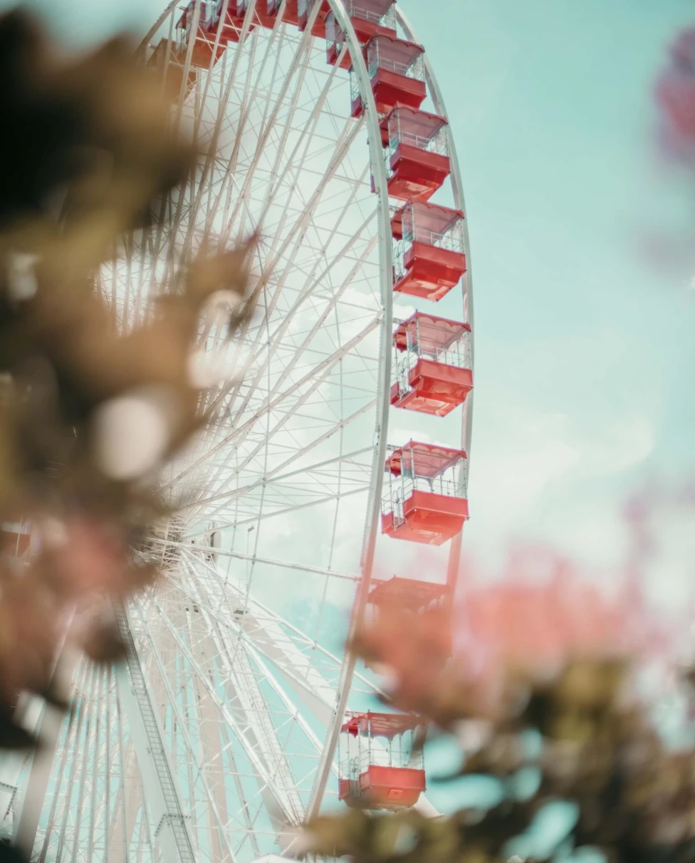 Pastel pink ferris wheel in Branson, Missouri on clear day.