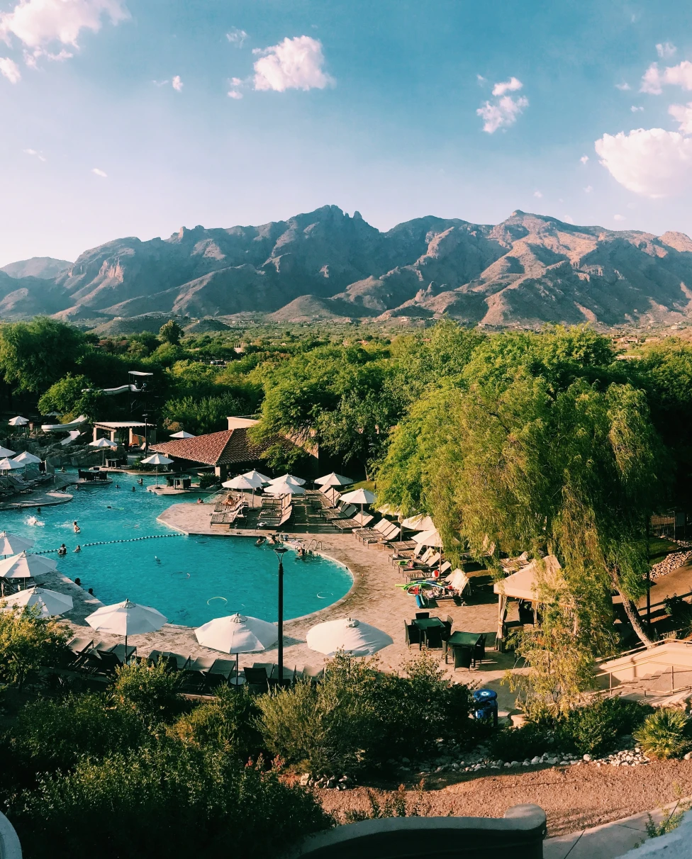 An arial view of the lake with huts on surrounding and trees