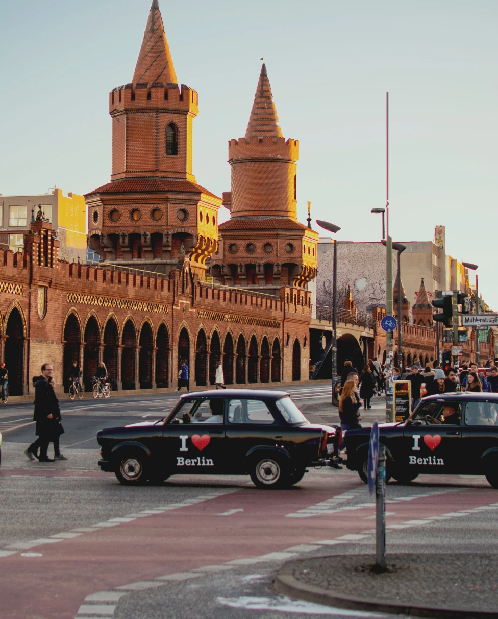 Yellow building and cars with pedestrians in Berlin