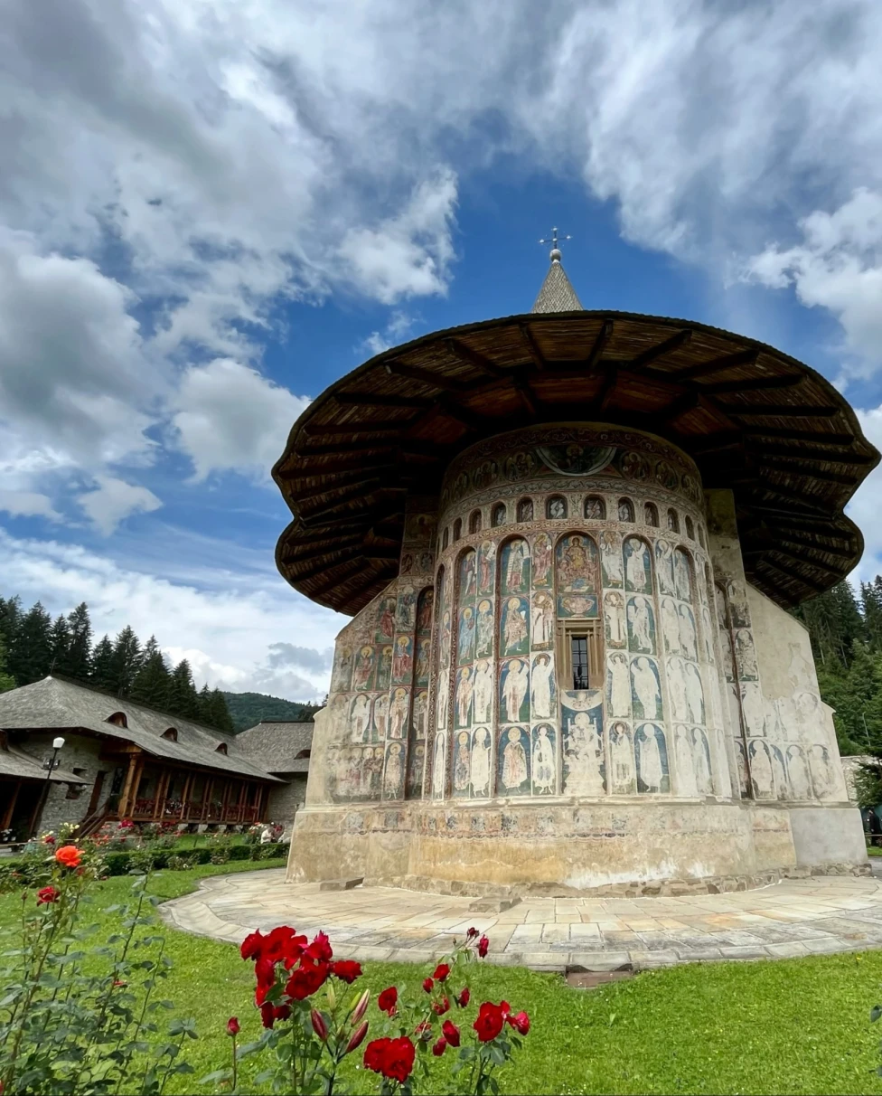 White monastery in a garden.