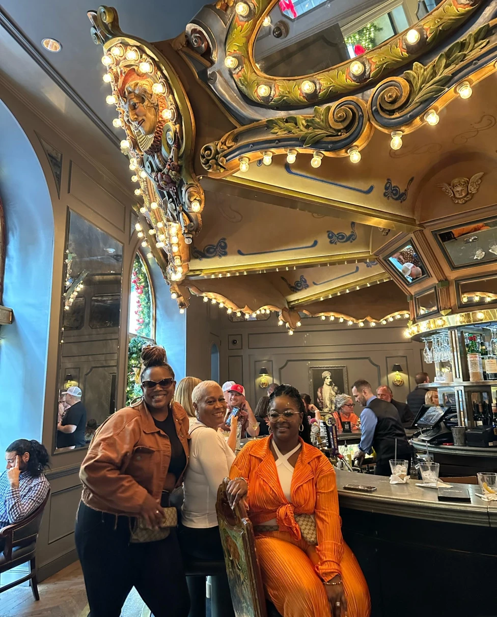 A group of women at a bar posing for a photograph