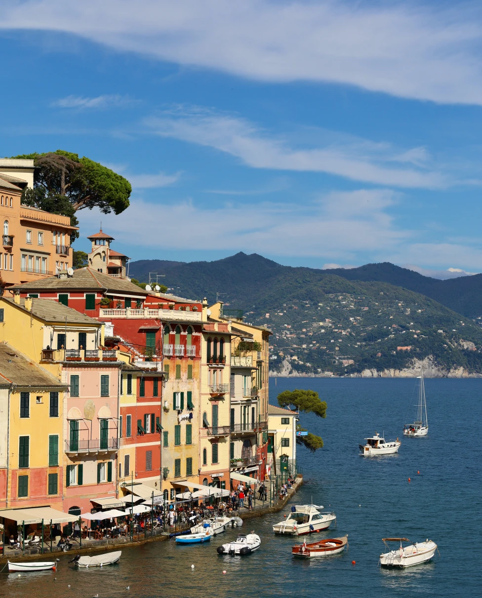boats in the water next to the coast during daytime