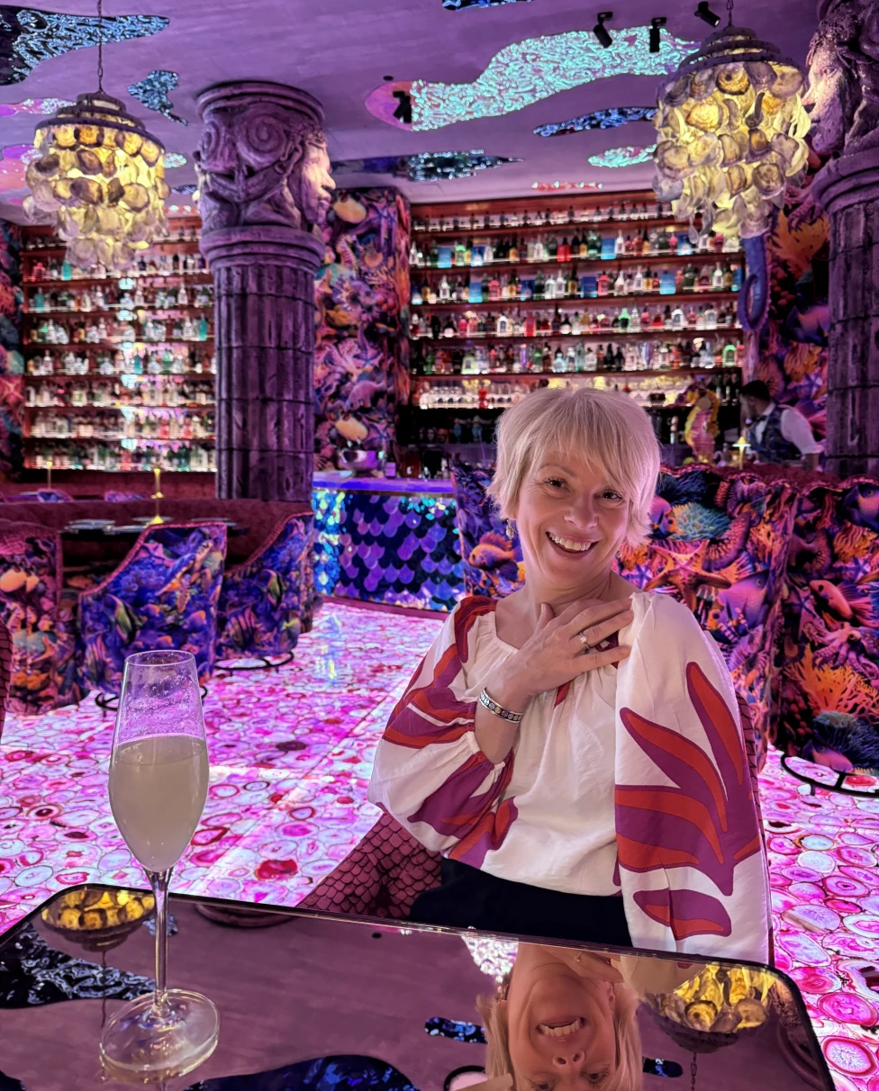 Woman in a colorful bar.