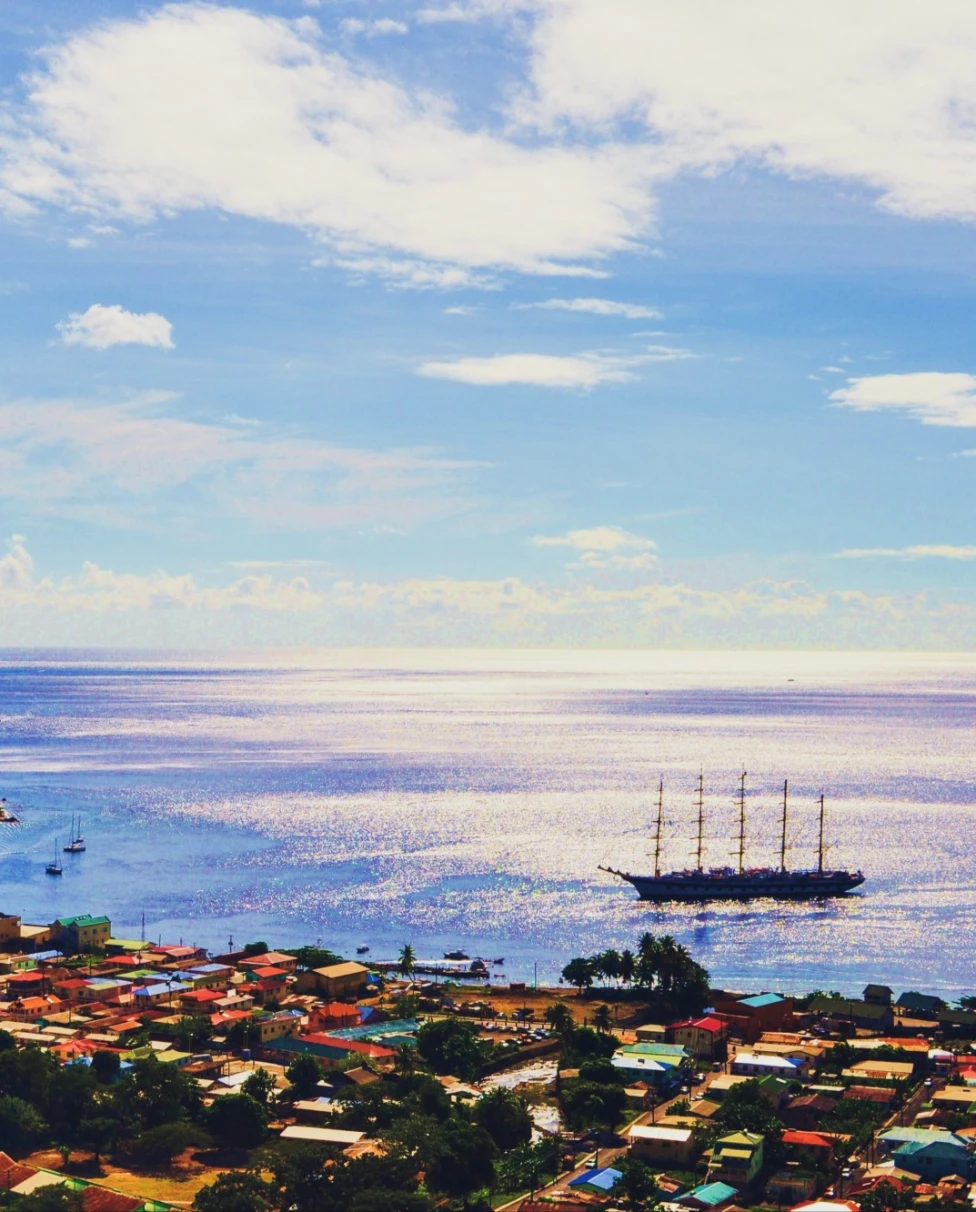 portside city near a large mountain jutting out of the sea