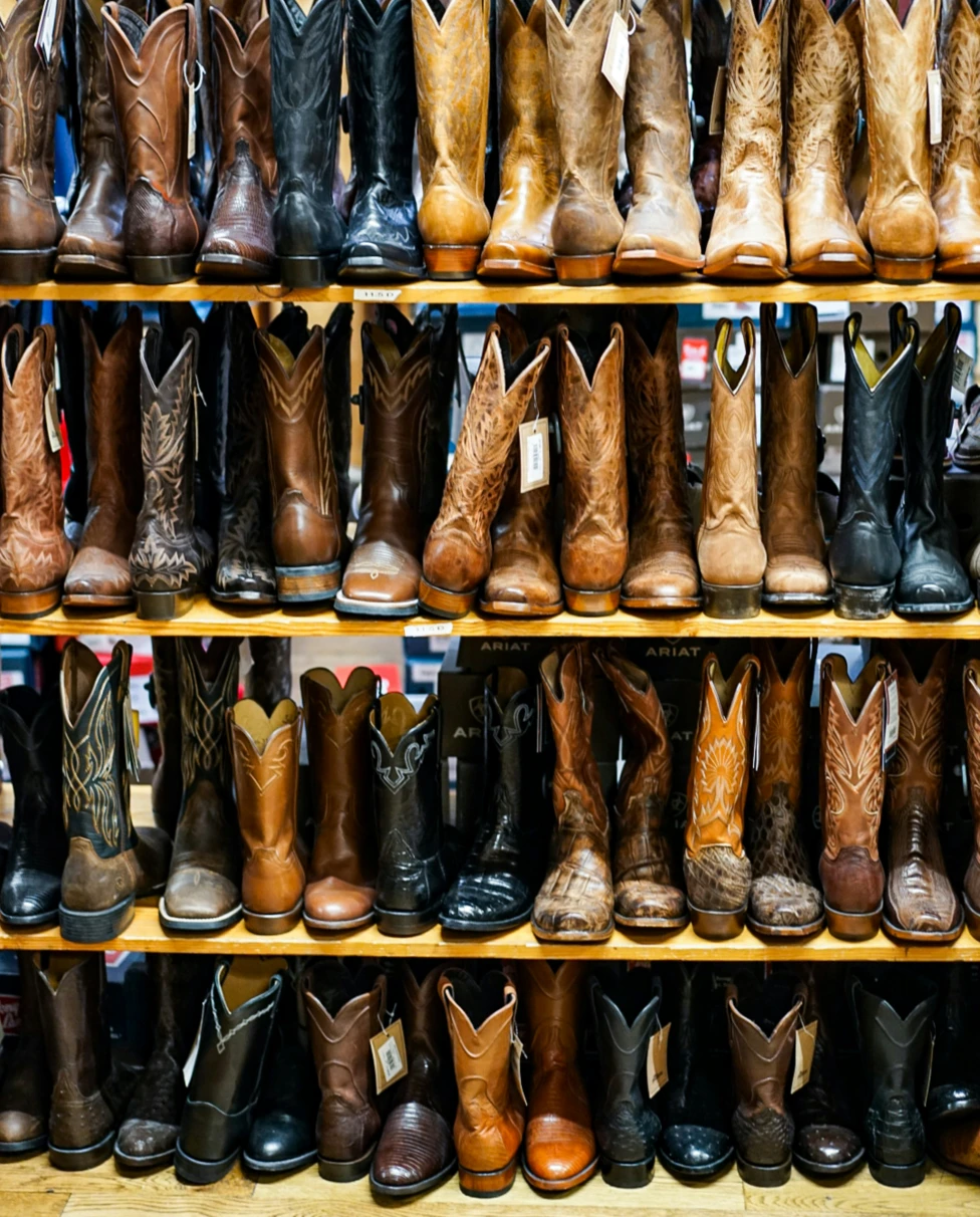 Shelves full of western boots displayed in a store.