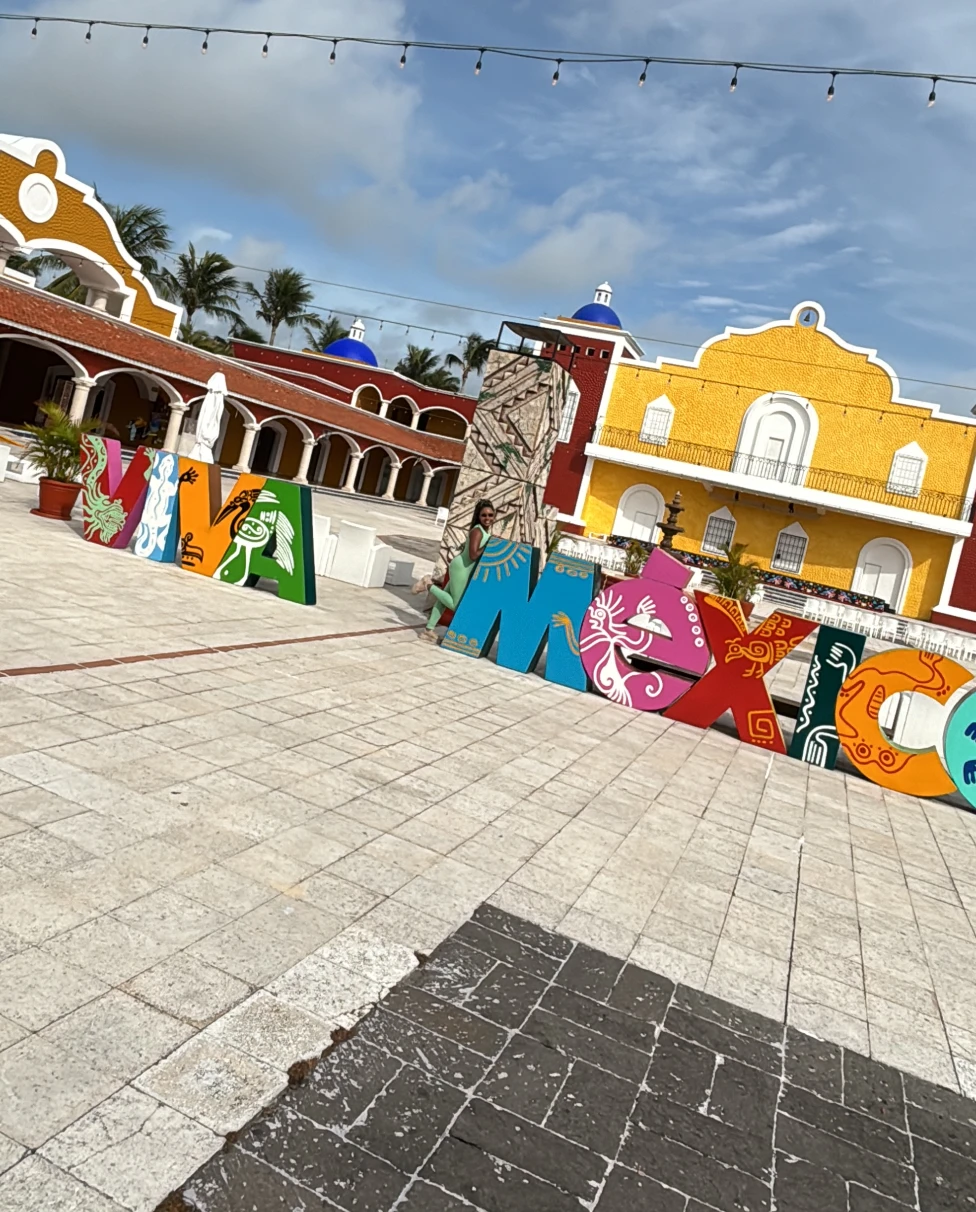 Bahia Principle Luxury Tulum is filled with brightly colored buildings on a cloudy day.