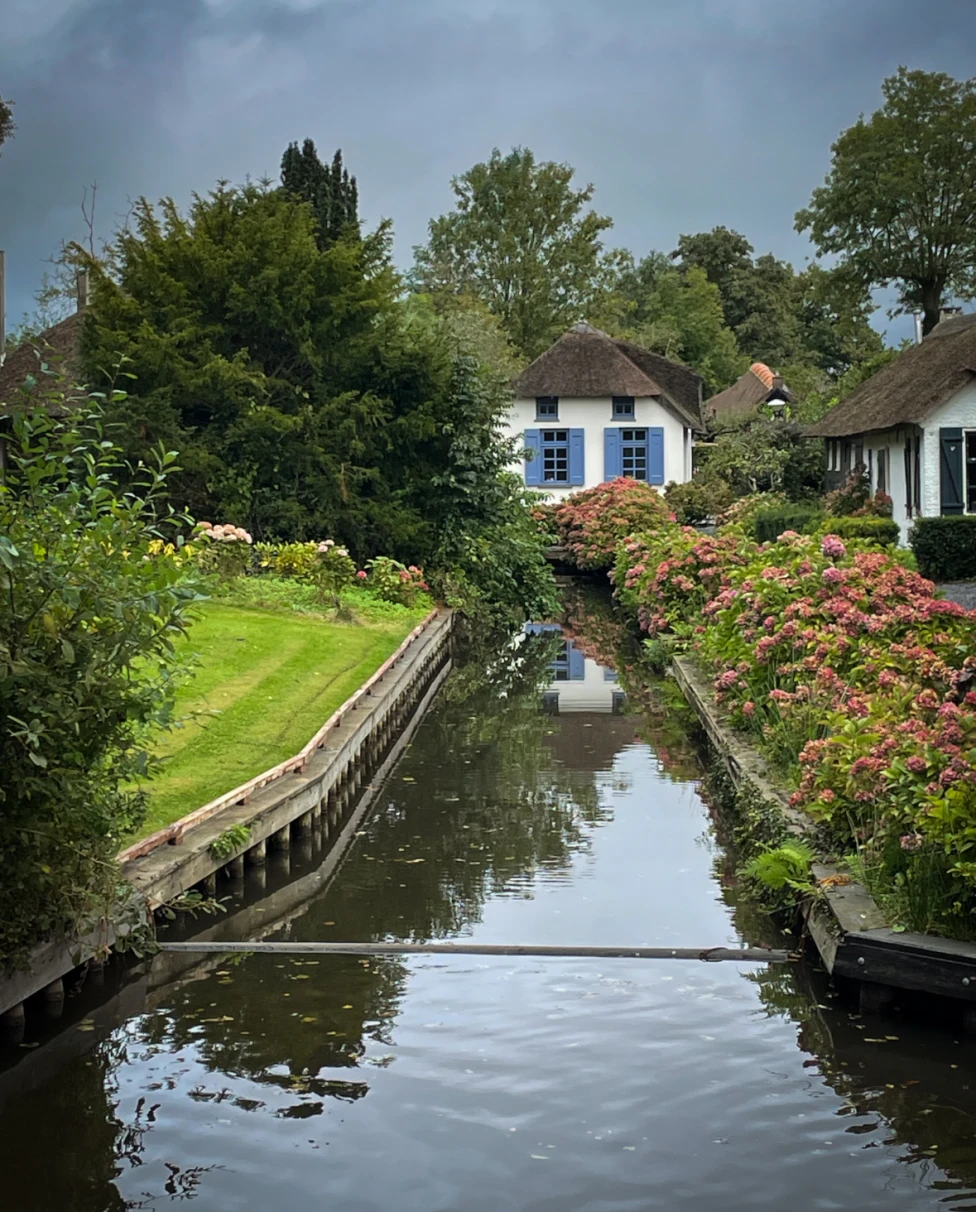 Canal flowing in front of houses.