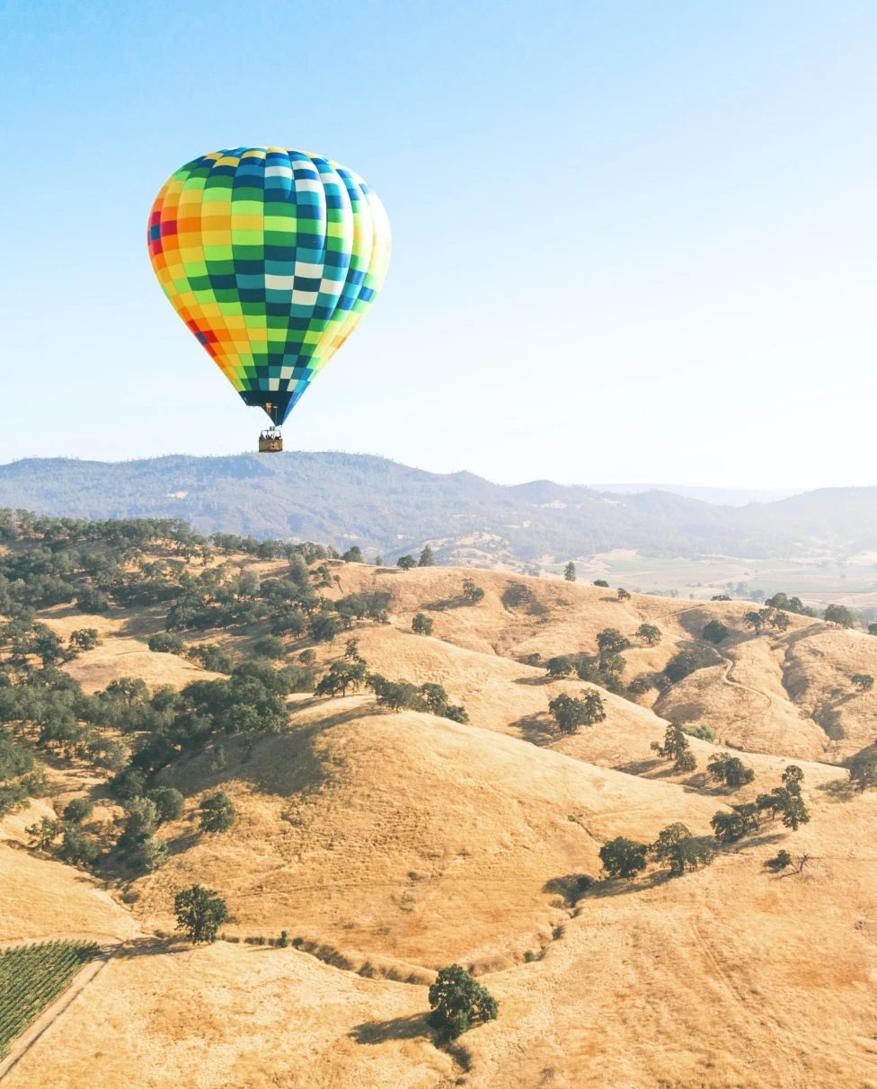 Hot air balloon with dry landscape at the back.
