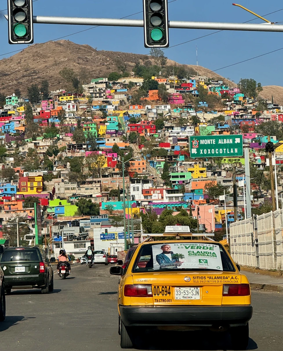 View of colorful buildings by the mountain in Oaxaca.