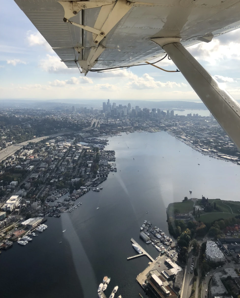 view of a city on the water from inside a seaplane